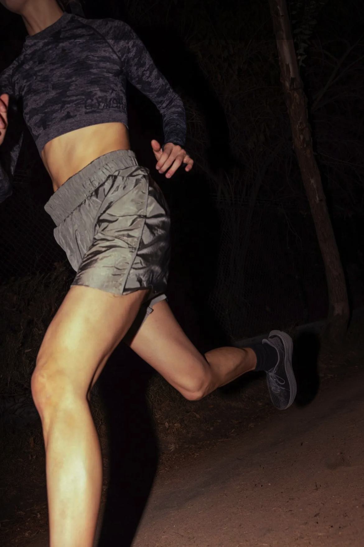 A woman running at night — training on her own terms, exactly the audience revvel is built for.